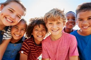 Image of smiling group of kids outside