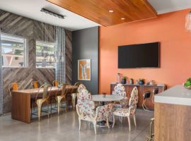 a meeting room with orange walls and a wooden ceiling