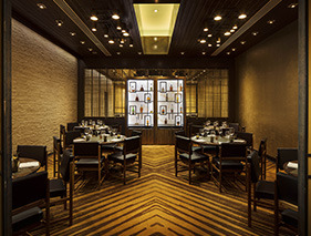 bourbon steak restaurant with some table inside and bar at the end