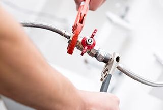 Plumber screwing plumbing fittings — Plumbing Repair in Tucson, AZ